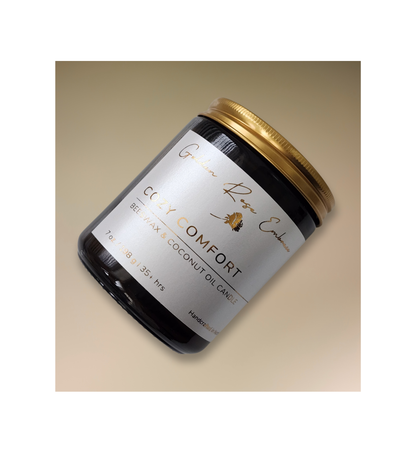 Cozy Comfort. 7oz Beeswax Candle. Amber glass jar. Gold metal lid. Cotton wick. 
A warm and cozy aroma of flannel, bergamot, mahogany, and musk. This fragrance will envelope you in comfort. 