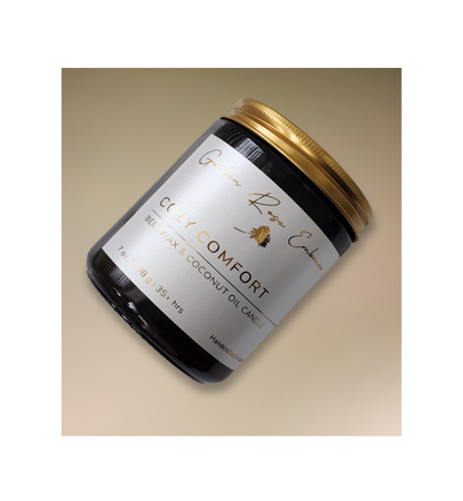 Cozy Comfort 7oz Beeswax Candle. Amber glass jar, gold lid, and woodwick. 
Notes of Bergamot, Mahogany, and Musk
Create a warm and cozy atmosphere with the aroma of flannel, bergamot, mahogany, and musk. This fragrance will envelope you in comfort. 