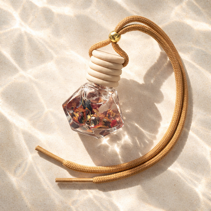 Car Diffusers. 8ML. Glass, wooden lid. Hangs from rearview mirror. Flor de Maga's - A paradise experience of tropical island vibes of hibiscus, jasmine, apple, pineapple, sugar, and coconut complemented by a touch of musk.