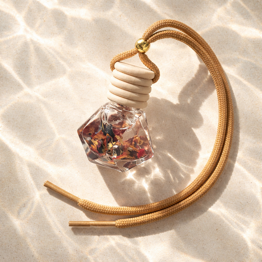 Car Diffusers. 8ML. Glass, wooden lid. Hangs from rearview mirror. Flor de Maga's - A paradise experience of tropical island vibes of hibiscus, jasmine, apple, pineapple, sugar, and coconut complemented by a touch of musk.