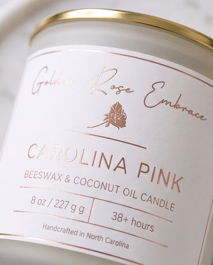 Carolina Pink 8oz Beeswax Candle. 
Frosted glass jar, gold metallic lid,, woodwick.
Notes of Apple, Pineapple, Peach, Red Fruits, Dewy Green, Ozone, Hibiscus, Jasmine, Cyclamen, Coconut, Caramelized Sugar, Musk. Experience the tropical island vibes of hibiscus, jasmine, apple, pineapple, sugar, and coconut complemented by a touch of musk.  Custom beeswax candle blended with organic coconut oil and fragrances infused with clean nontoxic fragrance and natural essential oils. 