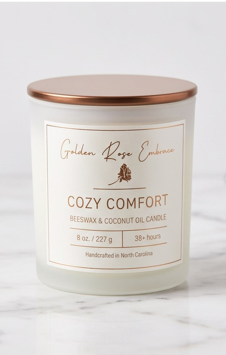 Cozy Comfort 8oz Beeswax Candle. Frosted glass jar, bronze metallic lid, and woodwick. 
Notes of Bergamot, Mahogany, and Musk. 
Create a warm and cozy atmosphere with the aroma of flannel, bergamot, mahogany, and musk. This fragrance will envelope you in comfort. 