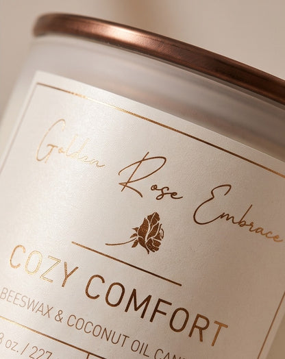 Cozy Comfort 8oz Beeswax Candle. Frosted glass jar, bronze metallic lid, and woodwick. 
Notes of Bergamot, Mahogany, and Musk. 
Create a warm and cozy atmosphere with the aroma of flannel, bergamot, mahogany, and musk. This fragrance will envelope you in comfort. 