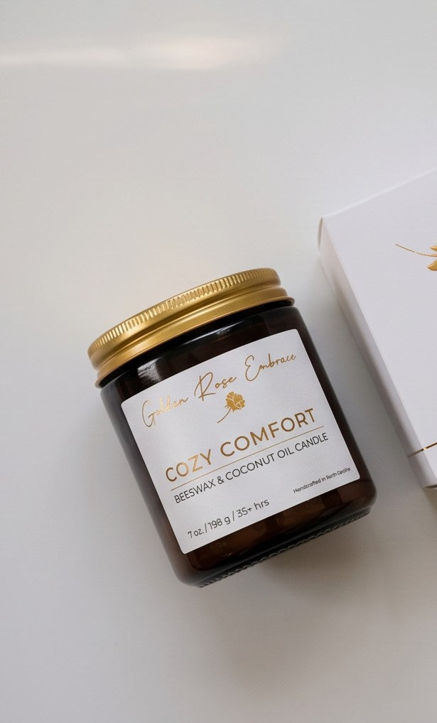 Cozy Comfort 7oz Beeswax Candle. Amber glass jar, gold lid, and woodwick. 
Notes of Bergamot, Mahogany, and Musk
Create a warm and cozy atmosphere with the aroma of flannel, bergamot, mahogany, and musk. This fragrance will envelope you in comfort. 