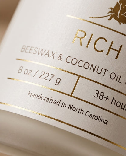 Rich 8oz Beeswax Candle.
Frosted glass, metallic gold lid, and woodwick.
Notes of Citrus, Cardamom, Palo Santo, Saffron, Violet, Wood, Sandalwood, Smoke, Amber.

A spicy warm woody scent infused with citrus, saffron, amber, violet & sandalwood. A luxurious rich fragrance that creates an inviting and sensual experience.

Custom beeswax candle blended with organic coconut oil and fragrances infused with clean nontoxic fragrance and natural essential oils. 
